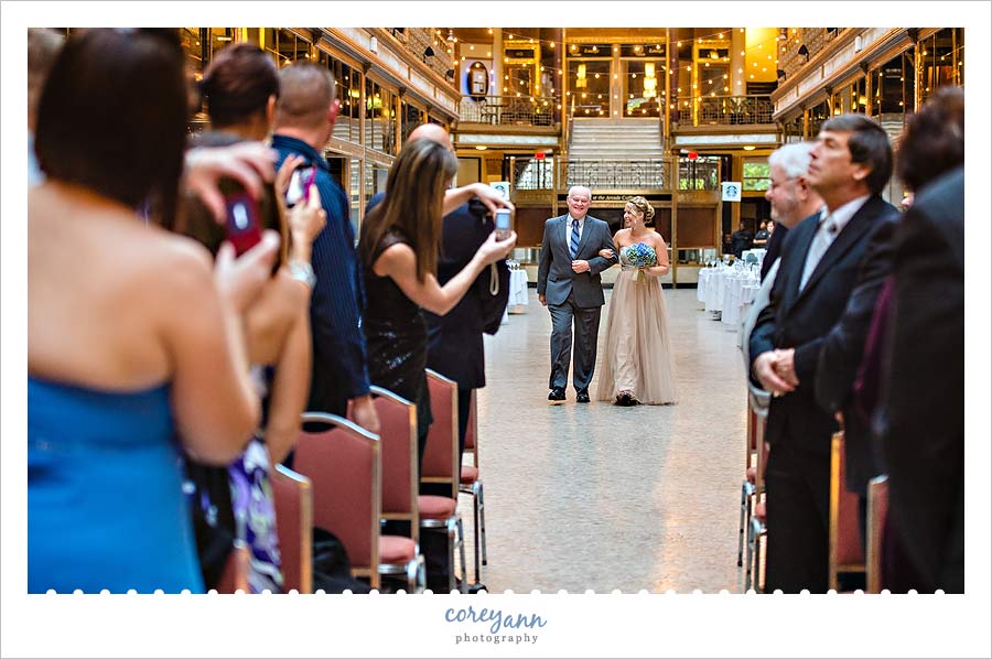 father of the bride escorting daughter down the aisle