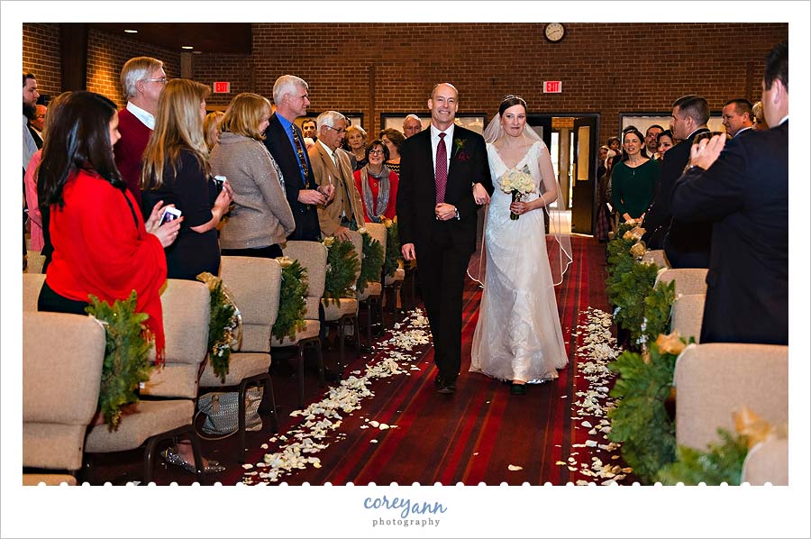 father walking down aisle in wedding ceremony