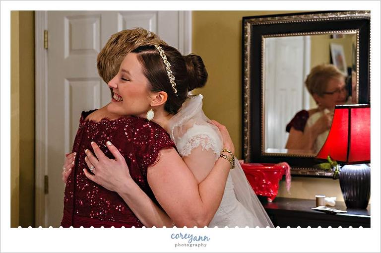 bride and mother of bride hugging after getting ready in connecticut