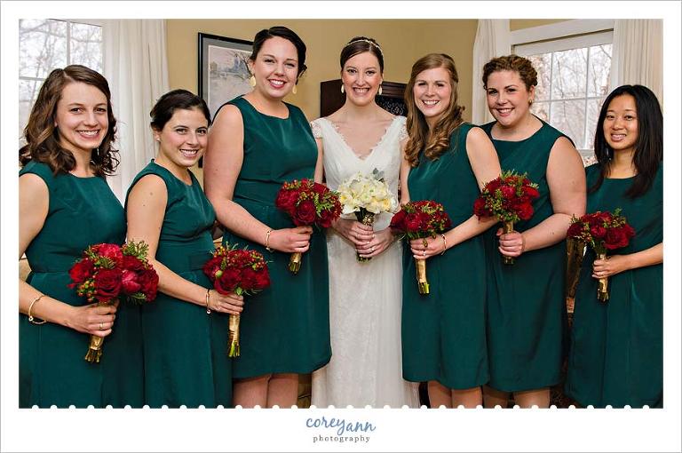 christmas wedding bridesmaids in green dress with red bouquets