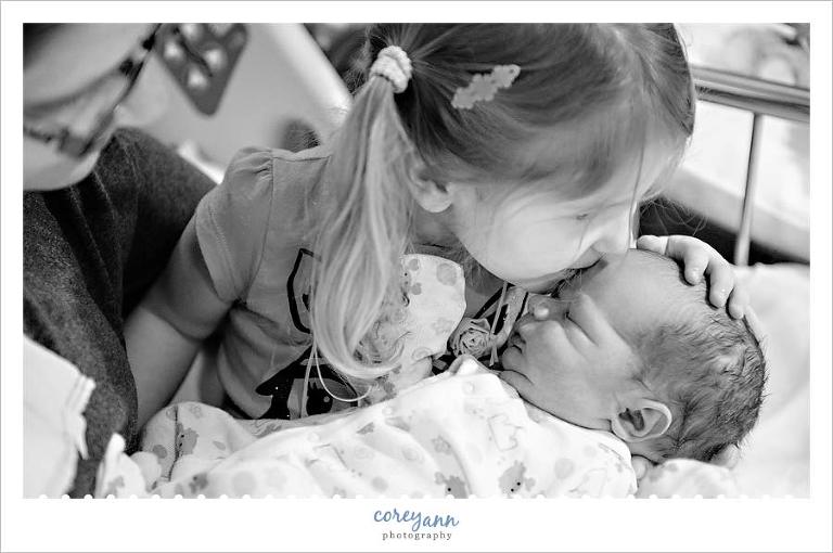 sister meeting new brother for the first time