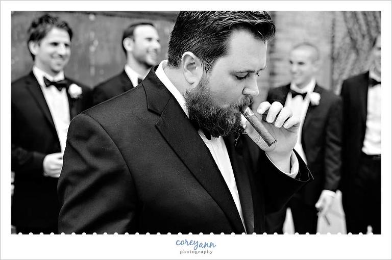 groomsman smoking a cigar in downtown cleveland