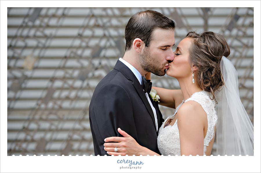 bride and groom kissing before wedding reception at windows on the river