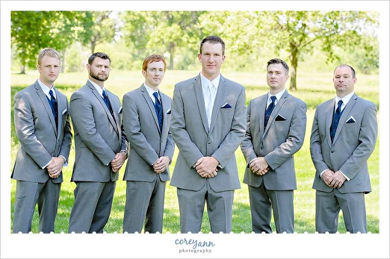 groom and groomsman in navy  ties in grey suits