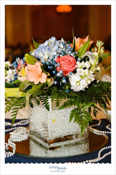 blue peach red and white centerpiece at wedding reception