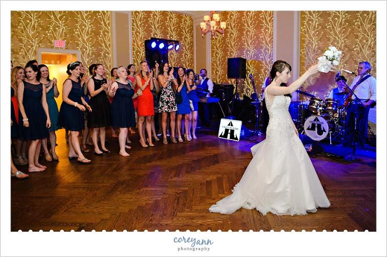 tossing the bouquet at wedding reception at brookside cc