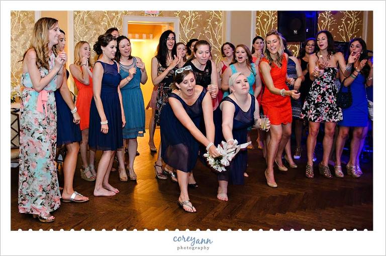 bridesmaids catching the bouquet at wedding reception