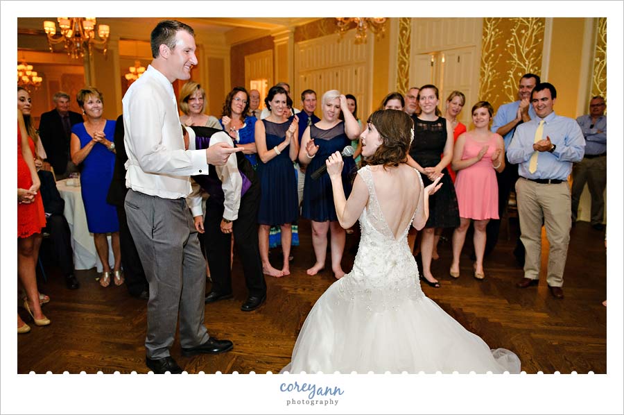 bride singing to groom at wedding reception
