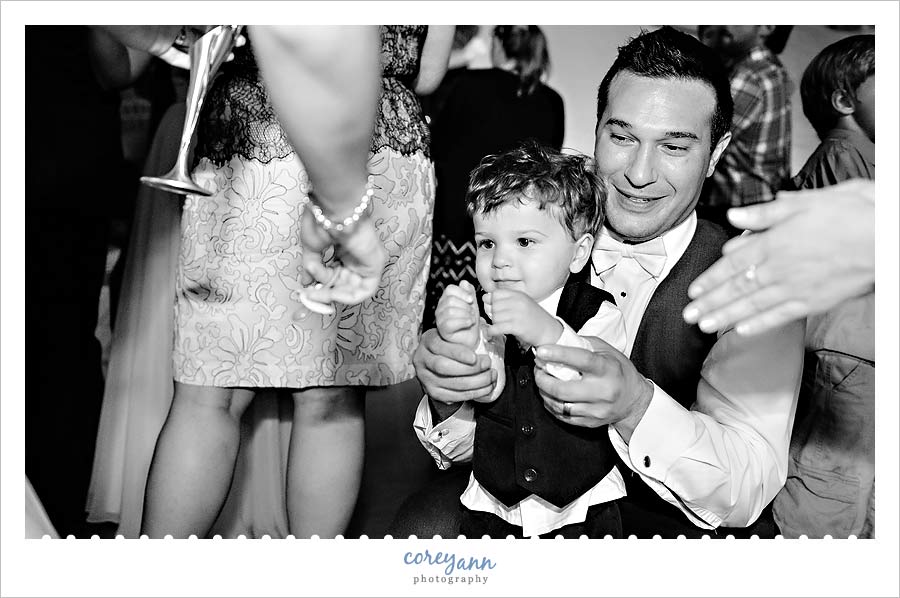 groom dancing with son on dance floor at wedding reception