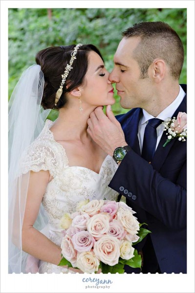 bride with headband and pale pink rose bouquet