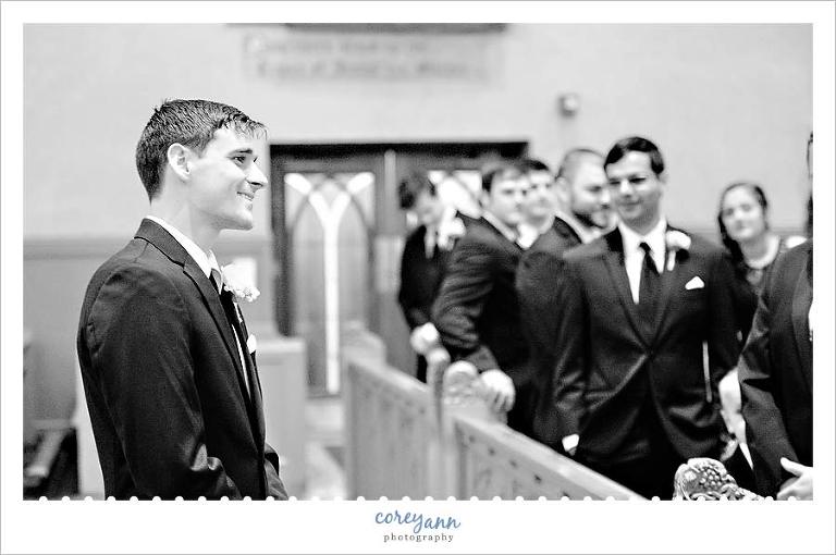 groom seeing bride for the first time as she walks down the aisle