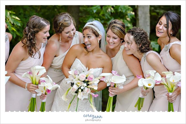 bride and bridesmaids having fun during pictures