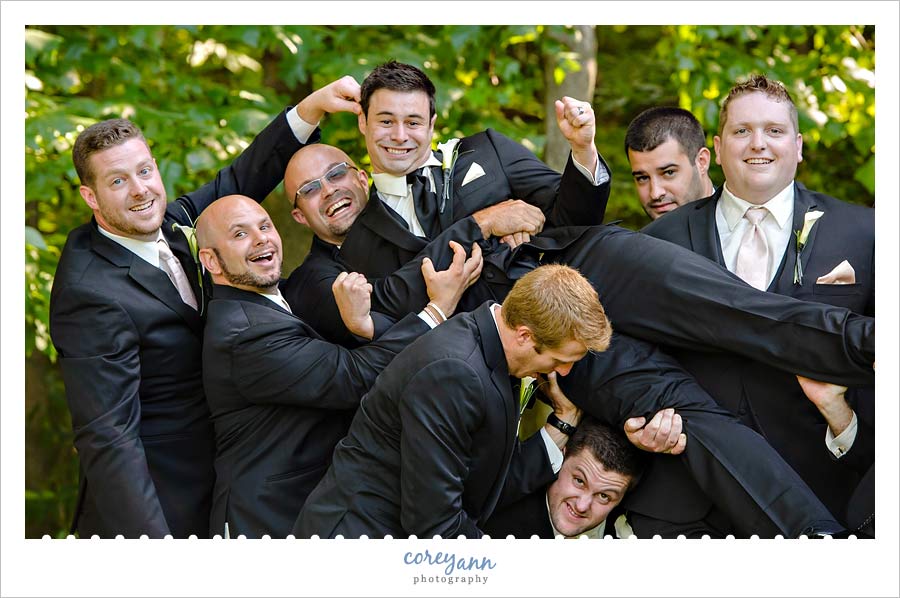 groomsman picking up groom