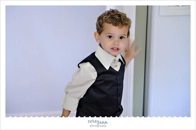 ring bearer posing for picture while getting ready