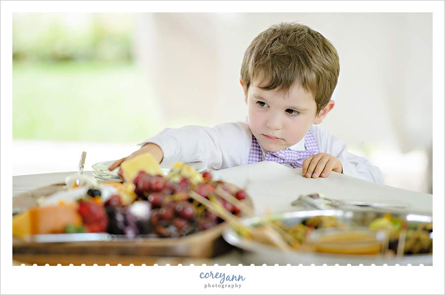 child stealing fruit from table at wedding