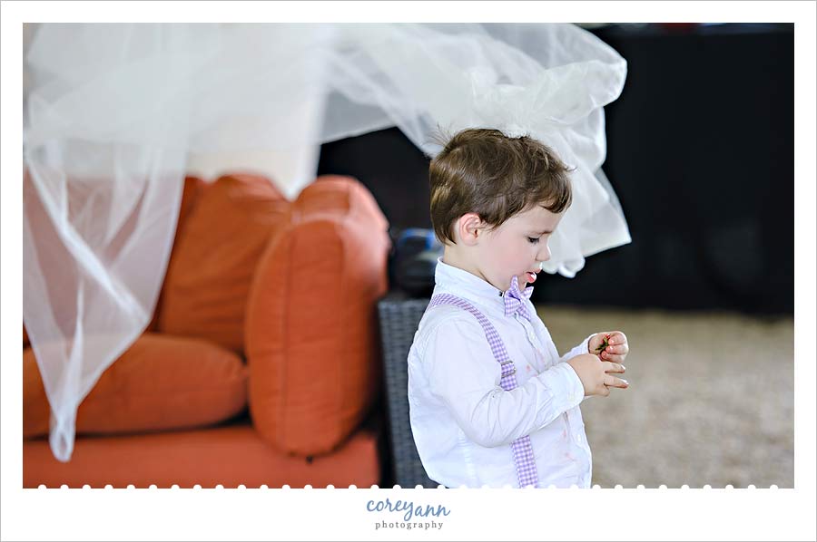 little boy wearing bride's veil during wedding reception