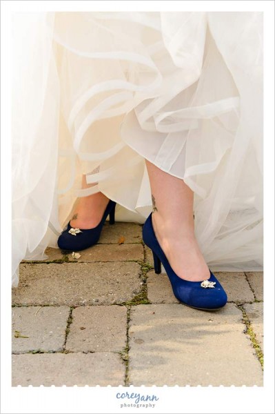 bride wearing blue shoes with broach 