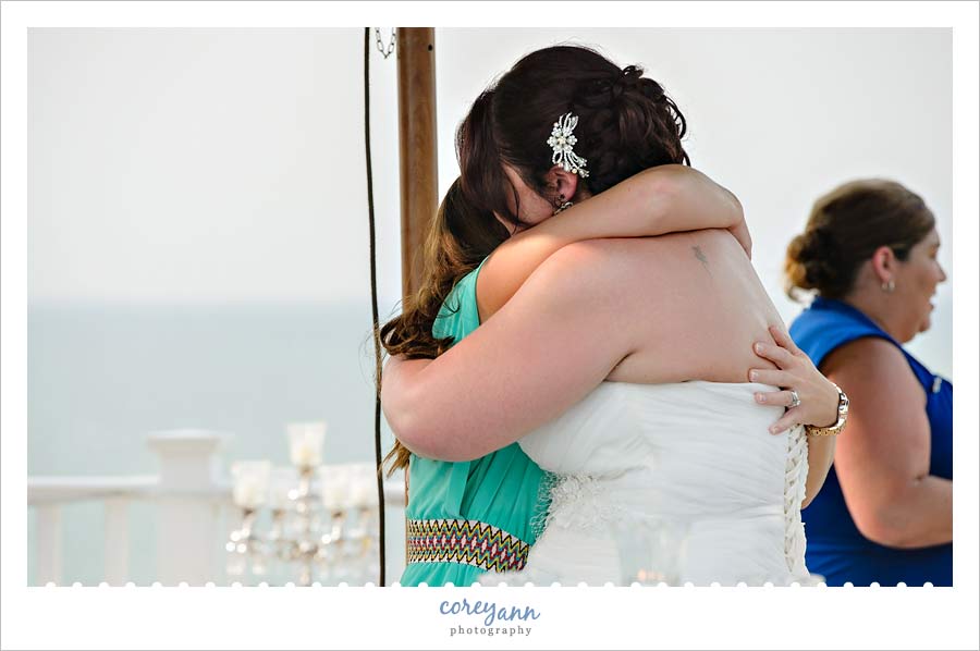 bride and sister hugging