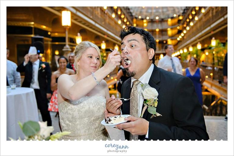 bride and groom eating first bite of cake
