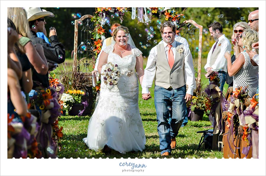bride and groom recessing with bubbles being blown by guests