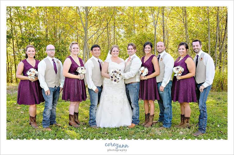 wedding party in purple and orange with jeans and cowboy boots