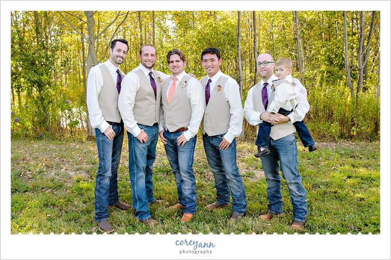 groom and groomsman in vests and jeans