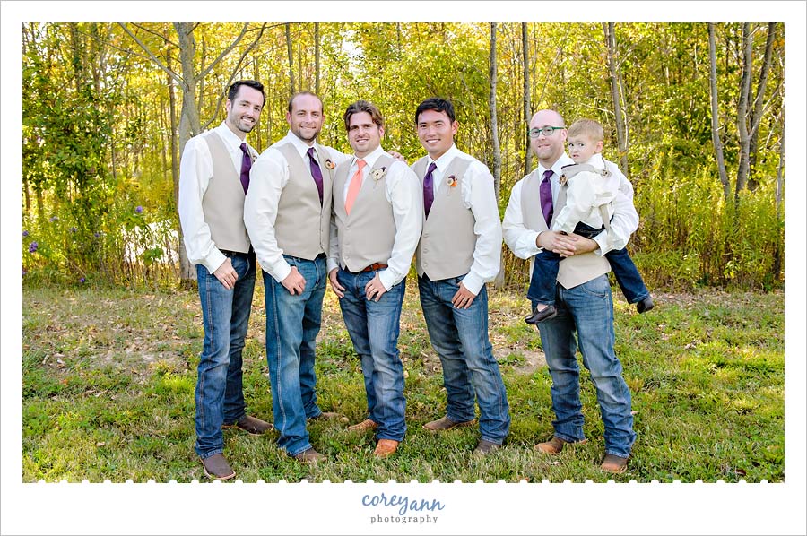 groom and groomsman in vests and jeans