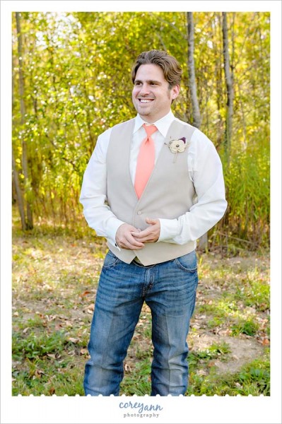 groom wearing vest and jeans