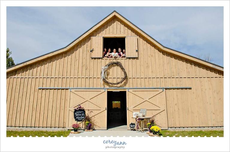 bride and bridesmaids in barn window