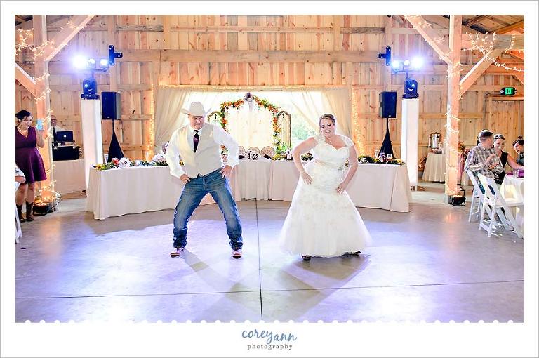 bride and father of the bride dancing during wedding reception to rap songs