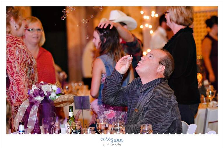 guest blowing bubbles during wedding reception