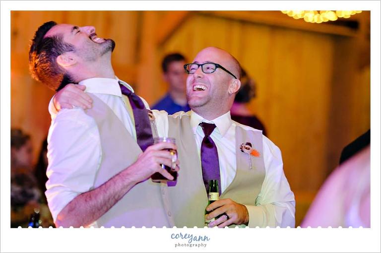 groomsman laughing during reception
