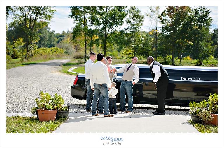 groom and groomsman laughing after getting out of BVIP limo