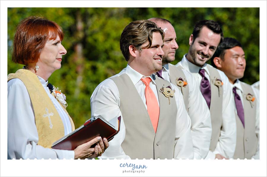 groom smiling when seeing his bride walk down the aisle for the first time