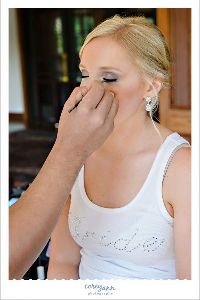 jason kelly doing makeup on a bride before her wedding