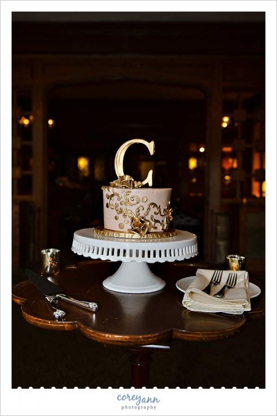 gold wedding cake by a cookie and a cupcake