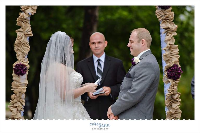 bride and groom exchanging custom vows during outdoor wedding ceremony