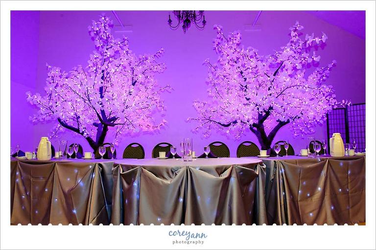 purple LED trees decorating wedding reception bridal table