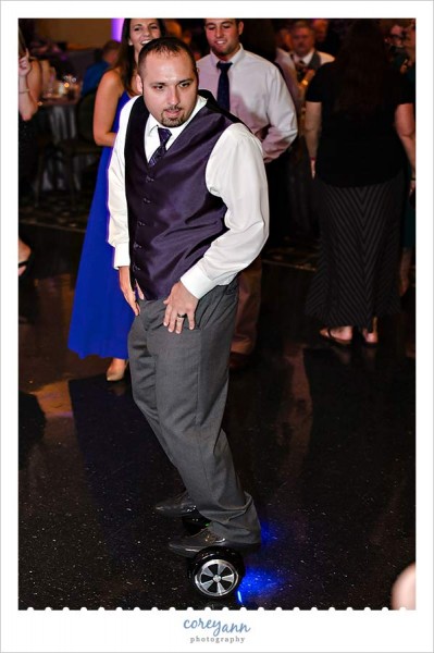 best man with swagway electric skateboard on dancefloor dancing to uptown funk during wedding reception