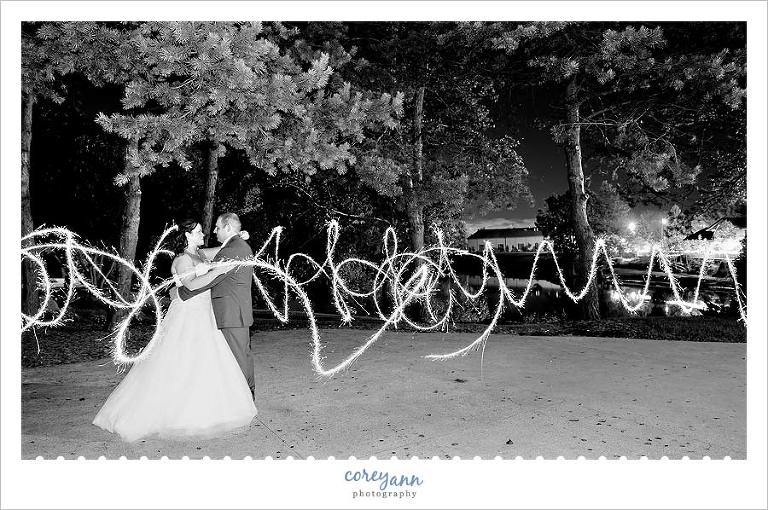 wedding picture with sparkler at  williams on the lake in medina