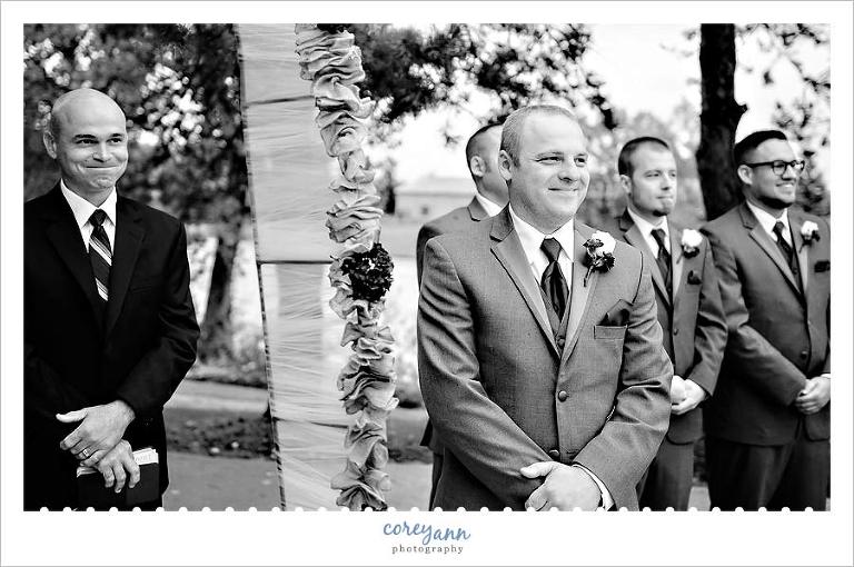 groom seeing bride for the first time as she walks down the aisle