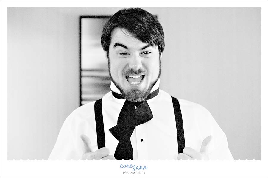 groom getting dressed before wedding in cleveland