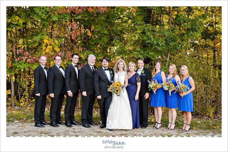 bridal party with parents with autumn leaves in ohio