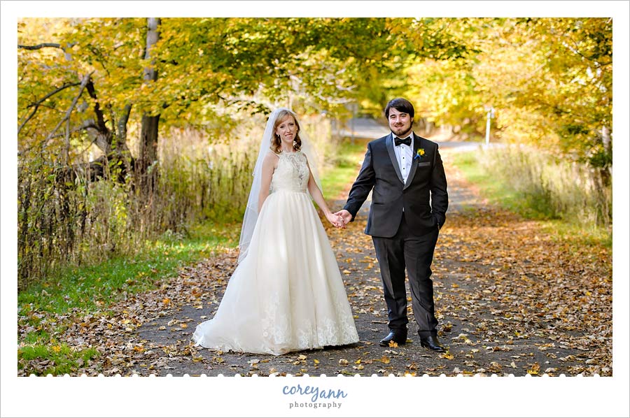 bride and groom holding hands near everett road covered bridge