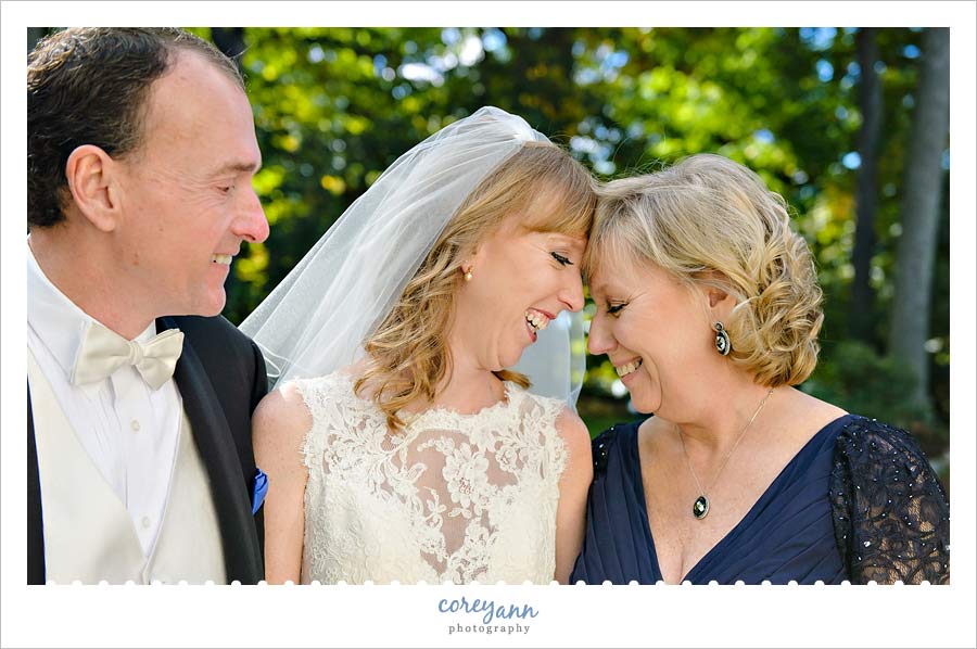 bride with parents before wedding ceremony