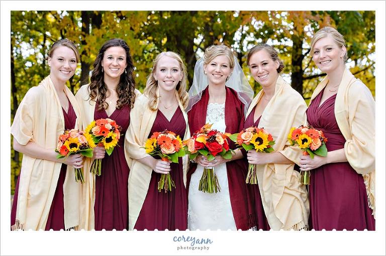 bride and bridesmaids with wine dresses and bold colored bouquets
