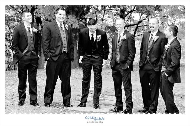 groom and groomsman laughing during portraits in ohio