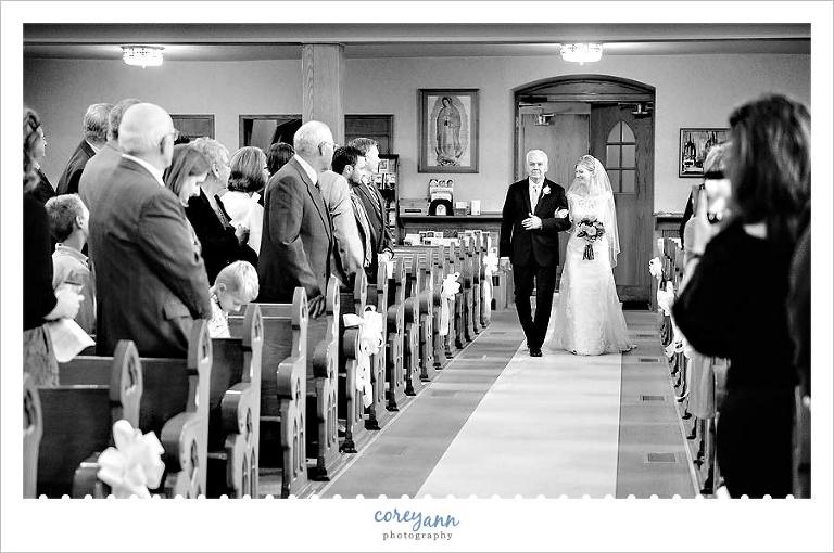 bride and father walking down the aisle at wedding ceremony at st marys in avon