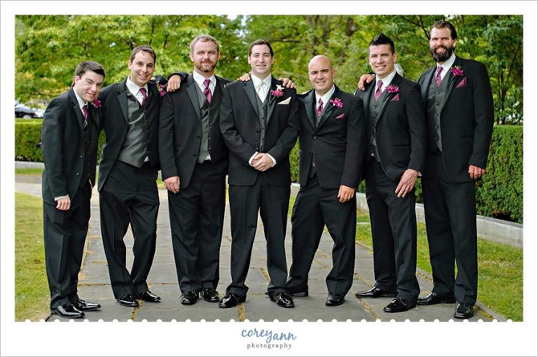 groom and groomsman in black tuxes with purple orchid boutonnieres 