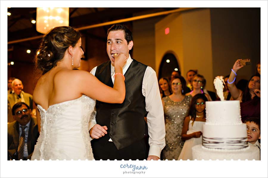 cutting a wild flour bakery cake during wedding reception